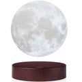 Levitating moon lamp floating above wooden base